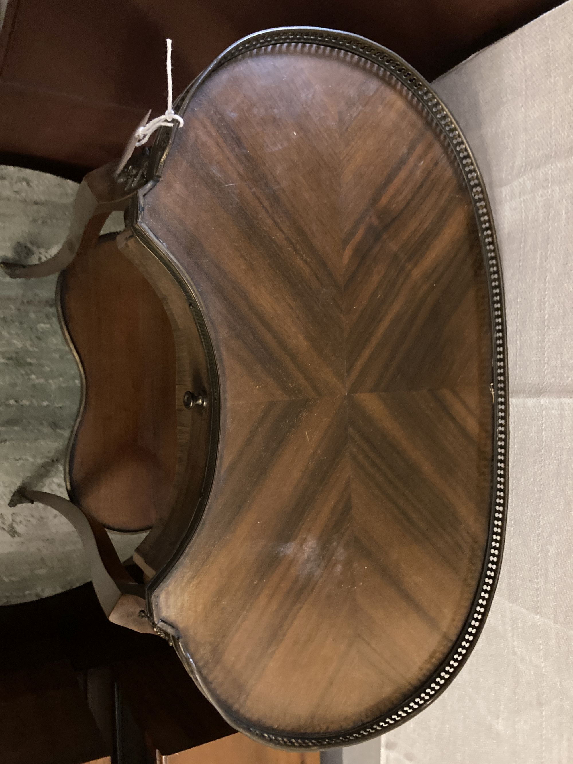 A Louis XVI style kidney top side table, with gilt brass gallery over a single drawer and upper tier, on slender cabriole supports, wid